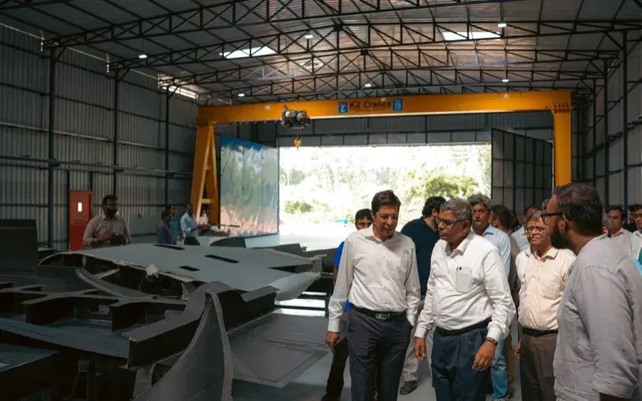 The team walking the composites bay